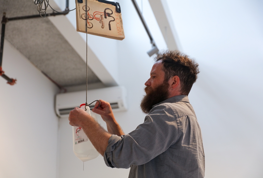 Visual Arts Fellow Jeff Gibbons installing work in the Hudson D. Walker Gallery